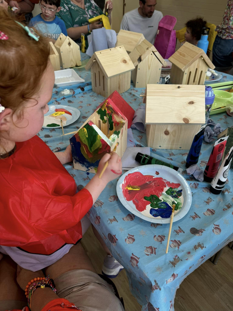 Children painting birdbox